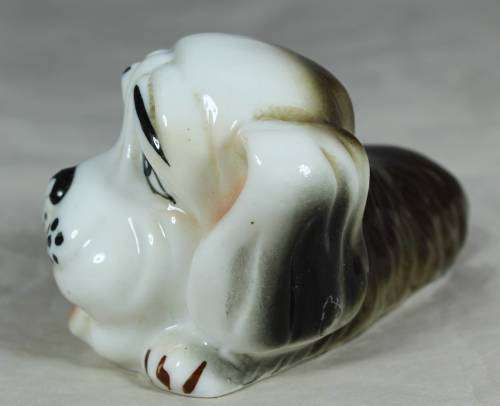 Porcelain dog lying down