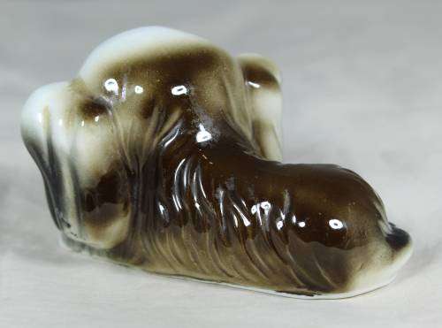 Porcelain dog lying down