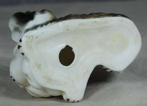 Porcelain dog lying down