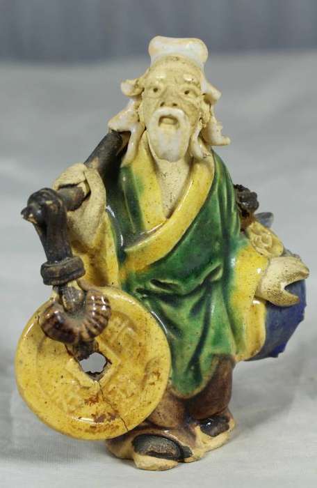 Mud man carrying large stones