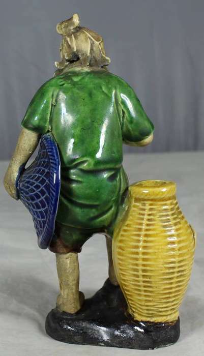 Mud man with a large wicker basket