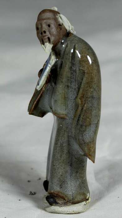 Collectible mud men - man holding a fan