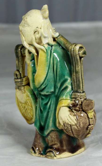 Collectible mud men - old man carrying a large disk