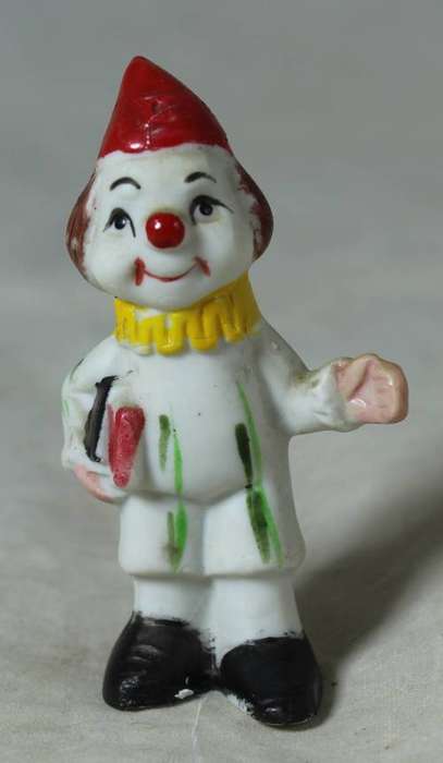 Miniature clown carrying books