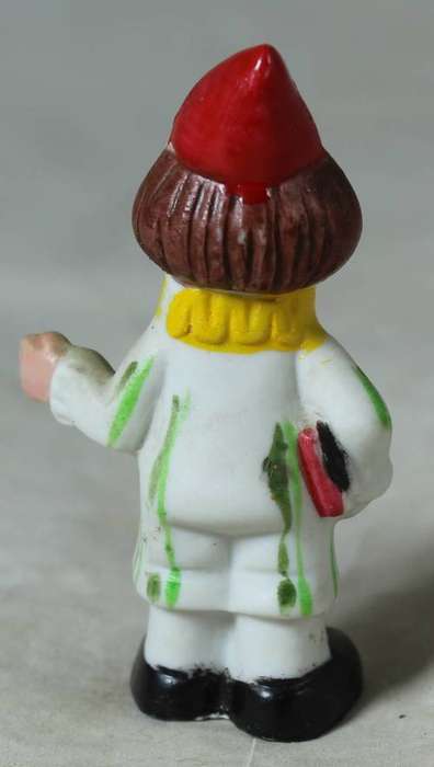 Miniature clown carrying books
