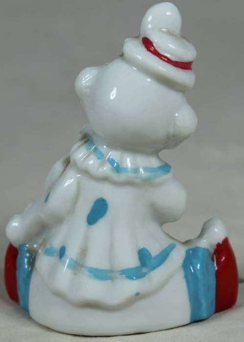 Miniature clown seated, playing a violin