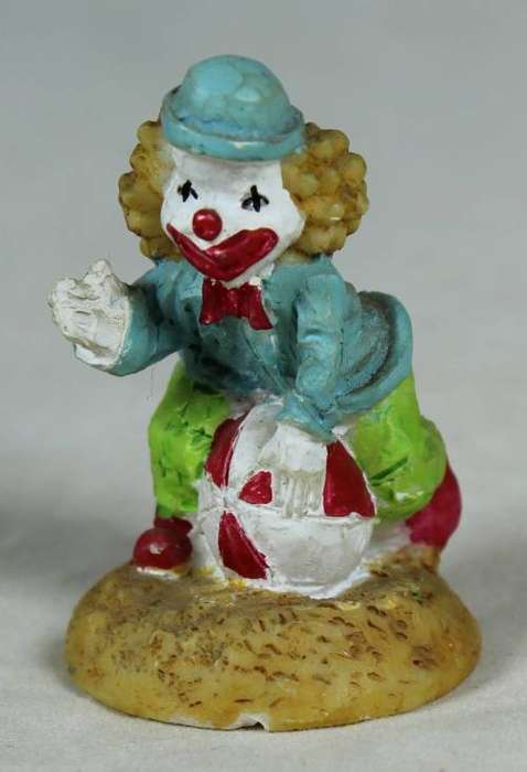 Miniature clown sitting on a balloon