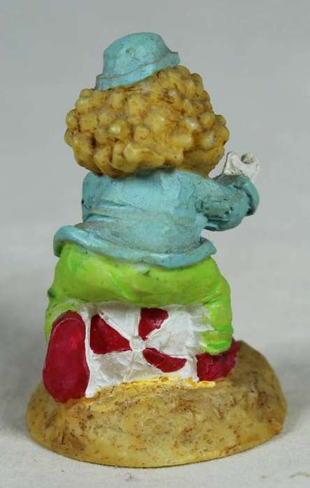 Miniature clown sitting on a balloon