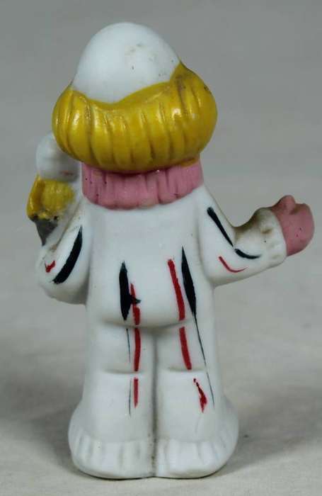 Miniature clown holding a bird