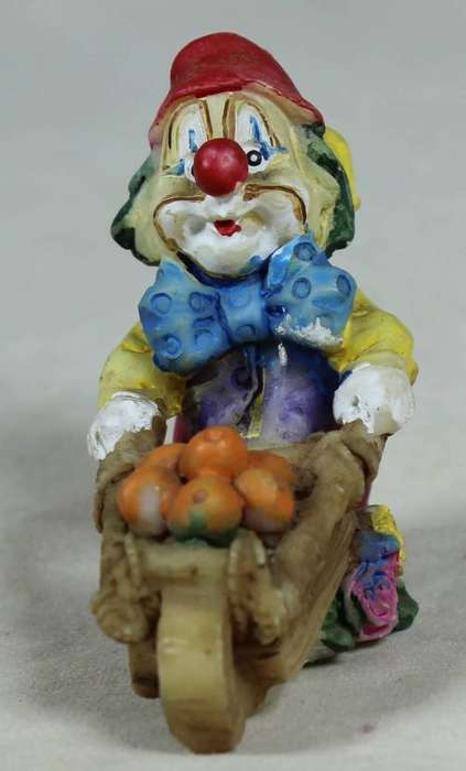 Miniature clown pushing a wheelbarrow