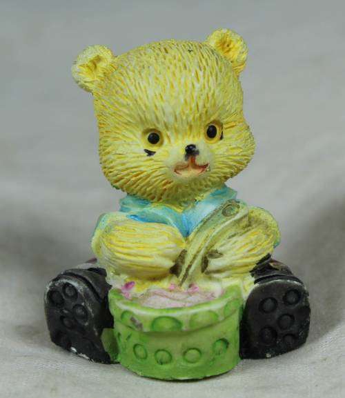 Miniature baby bear eating his porridge