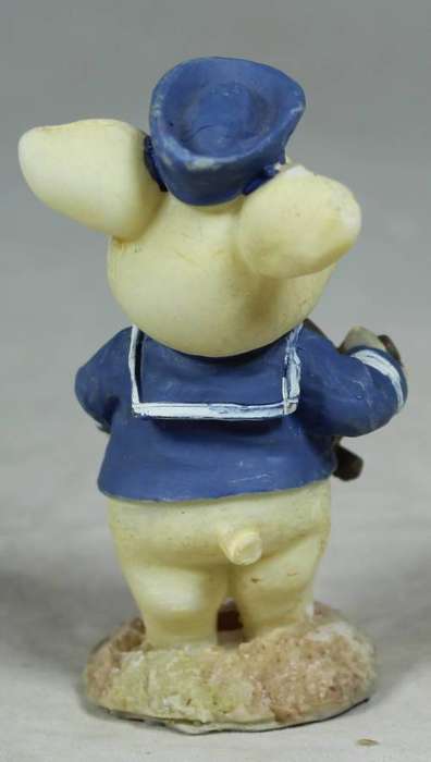 Miniature sailor with a ships wheel