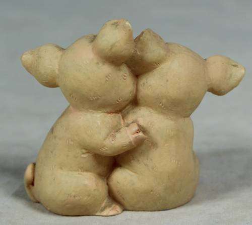 Miniature hugging piggy's