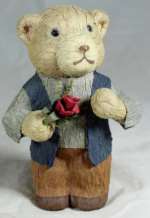 Father bear holding a flower