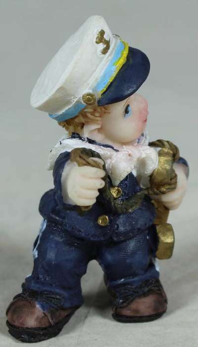 Kid sailor in blue holding an anchor