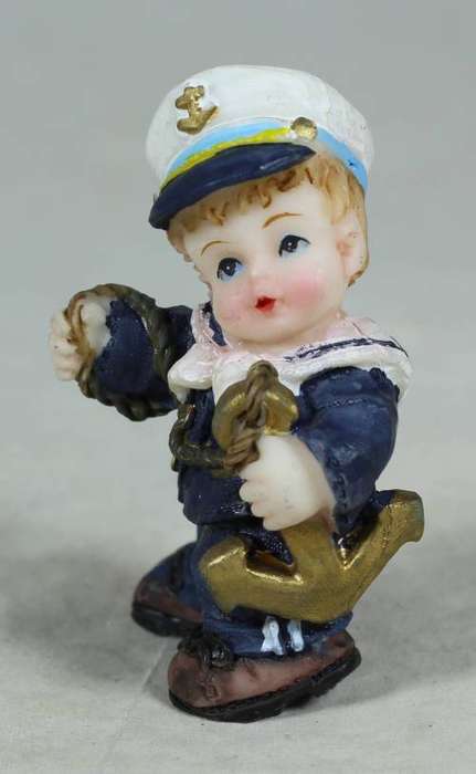 Kid sailor in blue holding an anchor