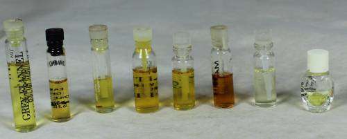 Eight half full bottles of perfume testers