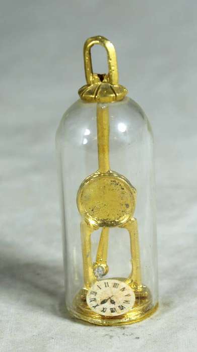 Miniature brass clock in dome