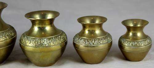 Five graduated brass bowls