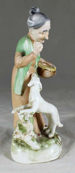 Old woman with dog figurine