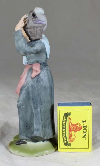 Old woman with basket figurine