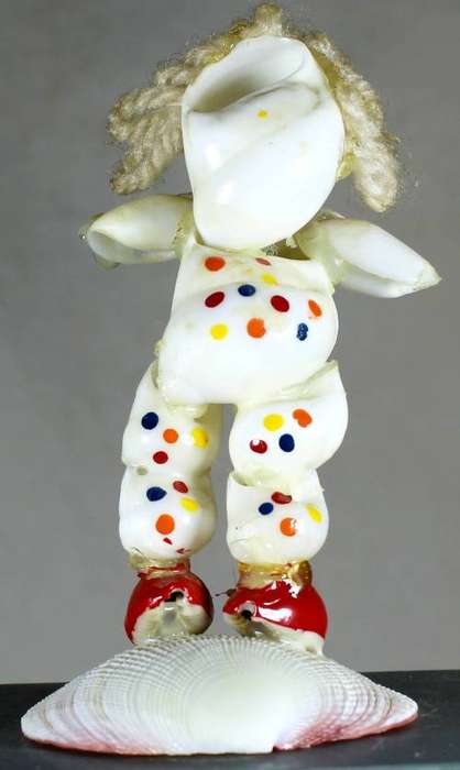 Clown figurine - polka dot suit standing on a shell