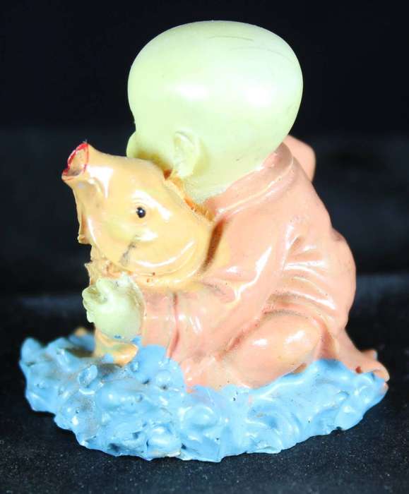 Little monk sitting with fish