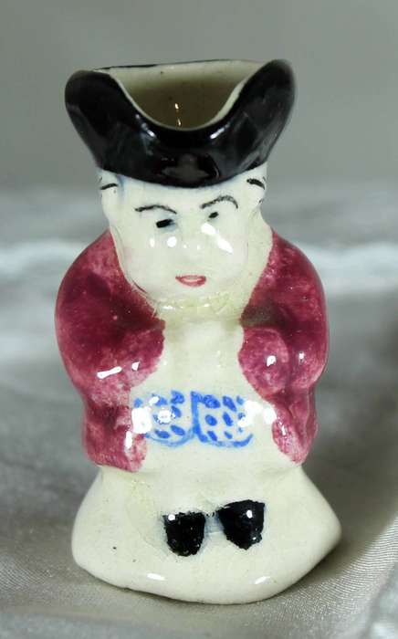 Miniature Toby jug with maroon jacket