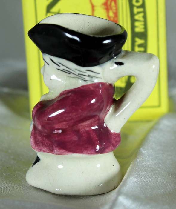 Miniature Toby jug with maroon jacket