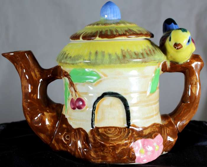 Small character teapot with bird and bungalow