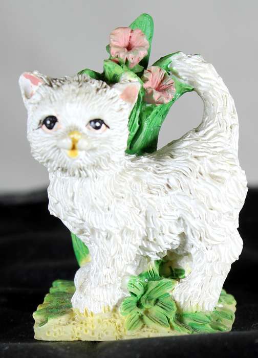Small white cat with flowers