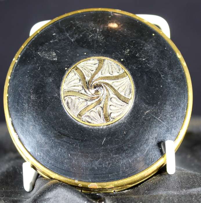 Embossed powder compact