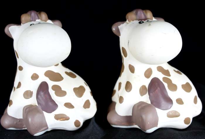 Pair of small ceramic cow money boxes