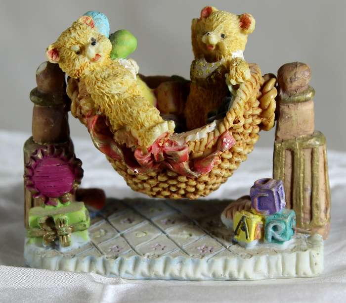 Two Bears Standing on a Swing