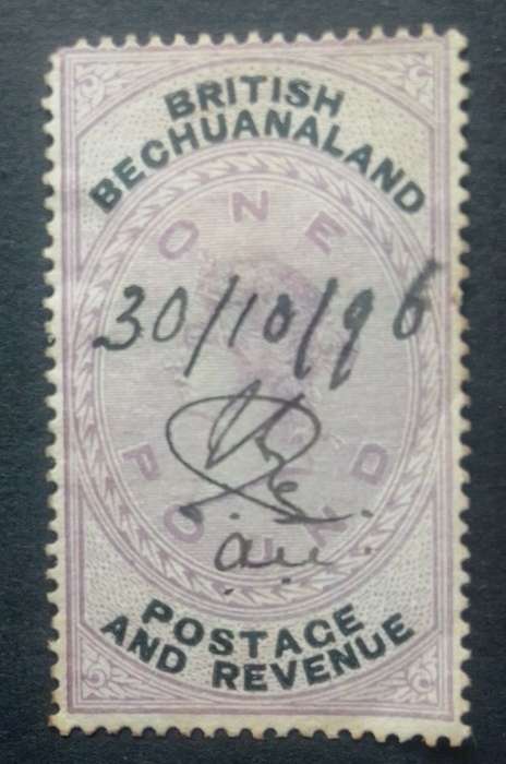 1887 1 pound purple black British Bechunaland stamp, used and hinged, Anker watermark right  sided.