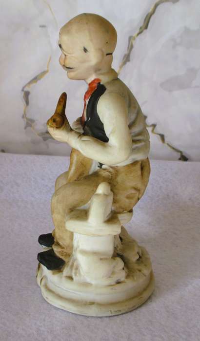 Vintage Bisque Porcelain Old Man Sitting on Bench with Cane/Pipe. 165mm hgh.