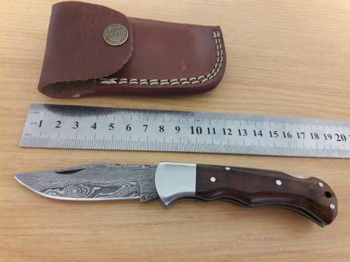 Handmade Damascus steel folding knife with Wooden handle scales.