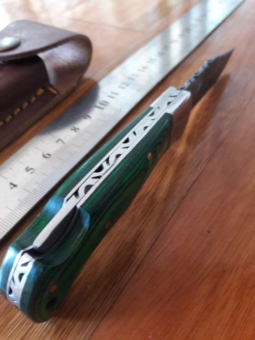 Handmade Damascus steel folding knife with WOODEN handle scales.