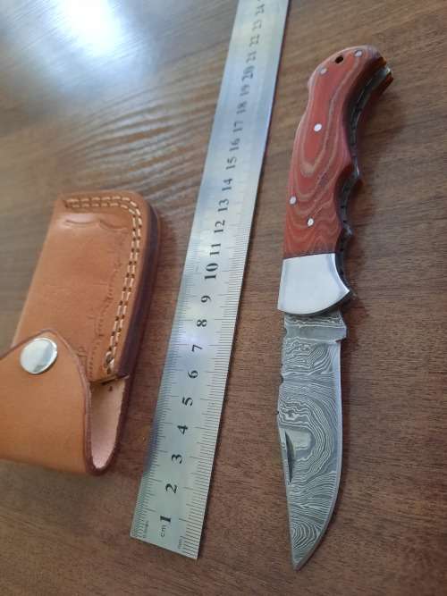 Handmade Damascus steel folding knife with MICARTA handle scales.