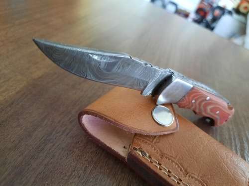 Handmade Damascus steel folding knife with MICARTA handle scales.