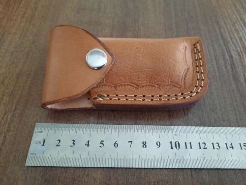 Handmade Damascus steel folding knife with MICARTA handle scales.
