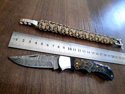 Handmade Damascus steel folding knife with Bull Horn handle scales. FREE SURVIVAL to the winner.