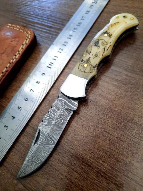 Handmade Damascus steel folding knife w Camel Bone Handle Scales. Art engraved.
