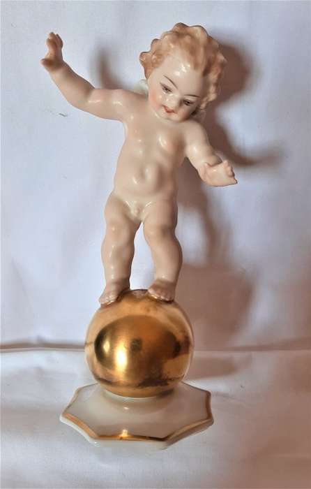 Superb Quality Hutschenreuther Gorgeous fat winged cherub standing on a gold ball, Signed Tutter.