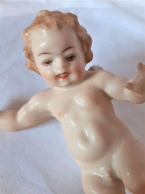 Superb Quality Hutschenreuther Gorgeous fat winged cherub standing on a gold ball, Signed Tutter.