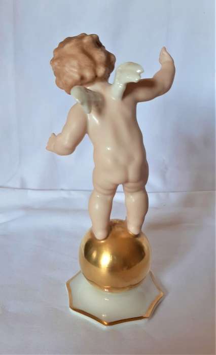 Superb Quality Hutschenreuther Gorgeous fat winged cherub standing on a gold ball, Signed Tutter.