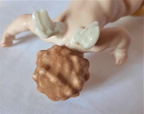 Superb Quality Hutschenreuther Gorgeous fat winged cherub standing on a gold ball, Signed Tutter.