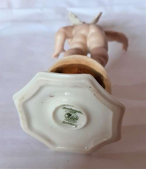 Superb Quality Hutschenreuther Gorgeous fat winged cherub standing on a gold ball, Signed Tutter.