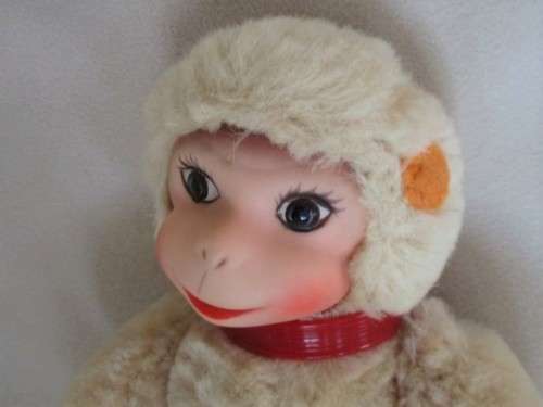 A VINTAGE 1950's/60's FULLY JOINTED MOHAIR RUBBER-FACED SCHUCO MONKEY WITH FELT EARS AND SQUEAKER