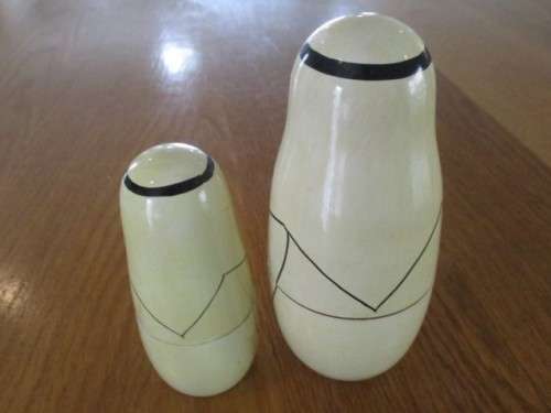AN UNUSUAL FOUR PIECE HAND PAINTED MATRYOSHKA/BABUSHKA NESTING DOLL SET